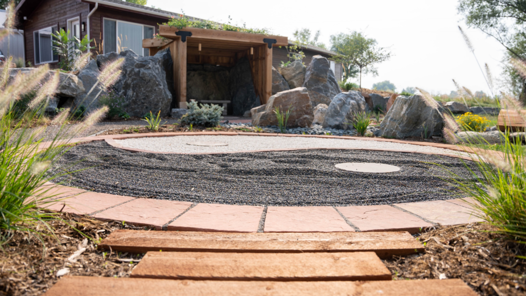 Explore the Gardens at The Beam and Bell steps leading to a rock garden with black and white stones