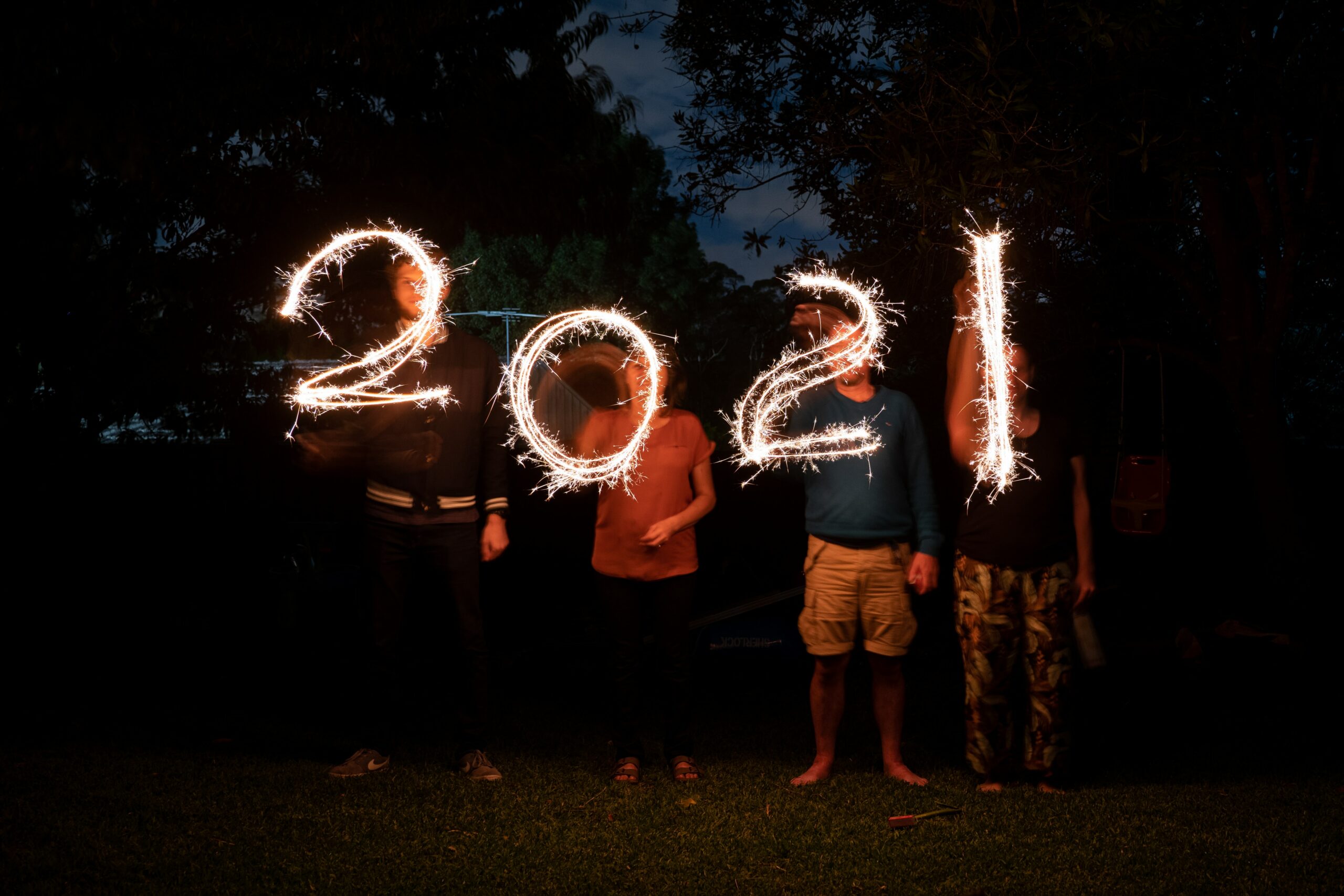 21 Things We Learned in 2021 four people holding sparklers in the shape of "2021"
