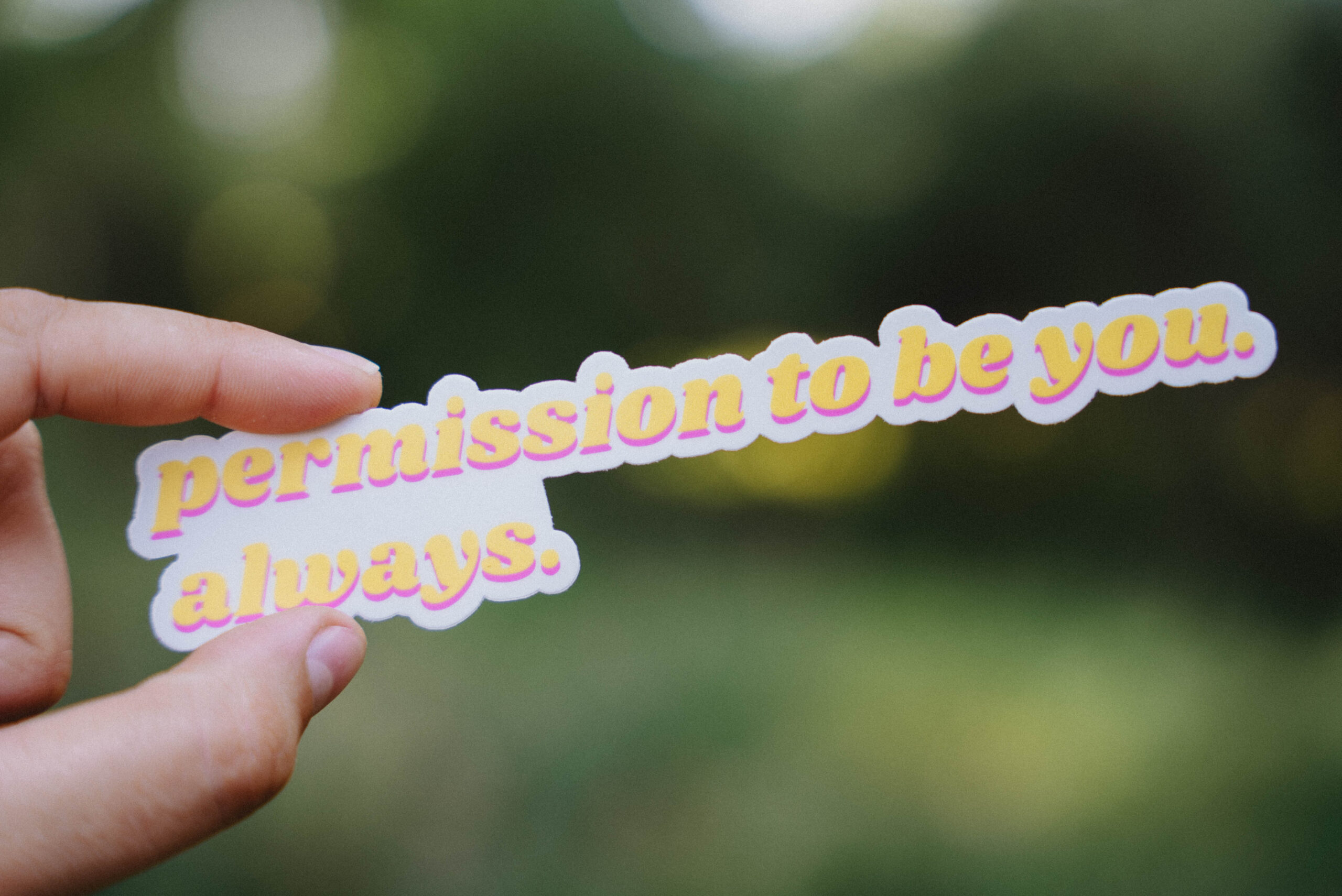 "Permission to be you. Always." Sticker Sticker that says "Permission to be you. Always." held up in front of a green background