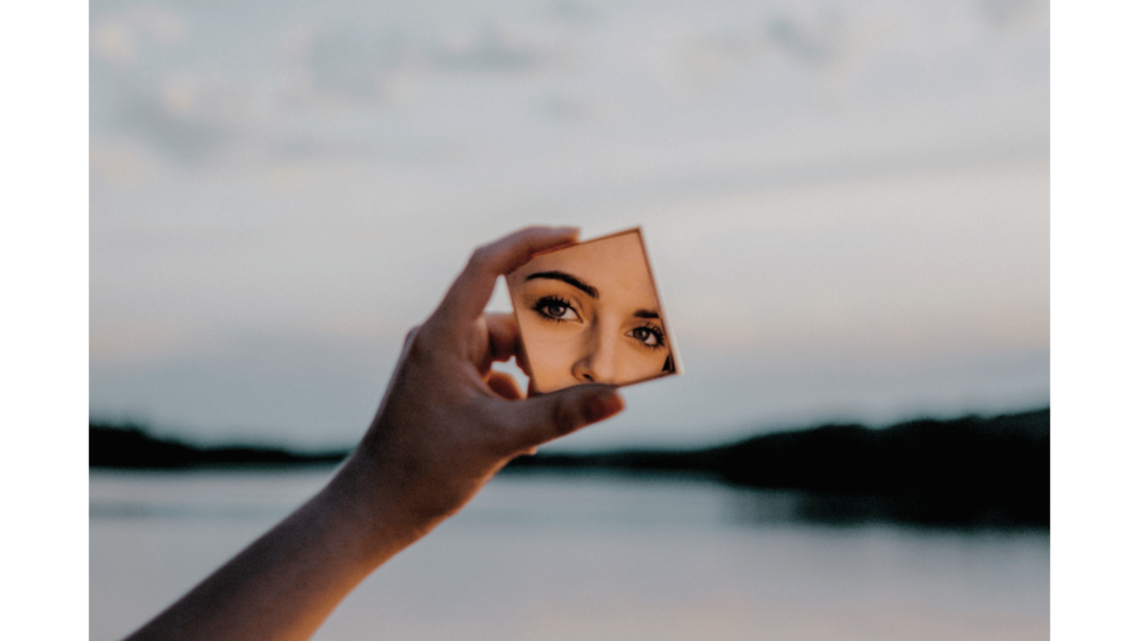 92: A Guided Meditation for Your Own Lake Journey Reflection of Woman's Face In Small Mirror She Holds in front of lake