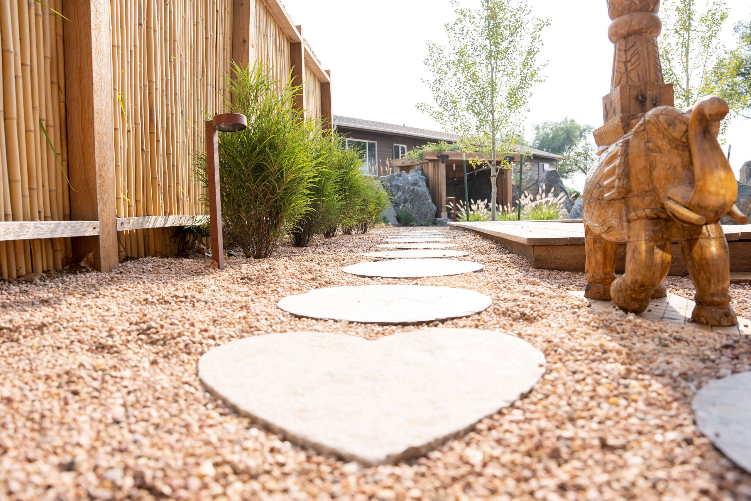 Heart shaped rock pathway in mediation garden with wood elephant