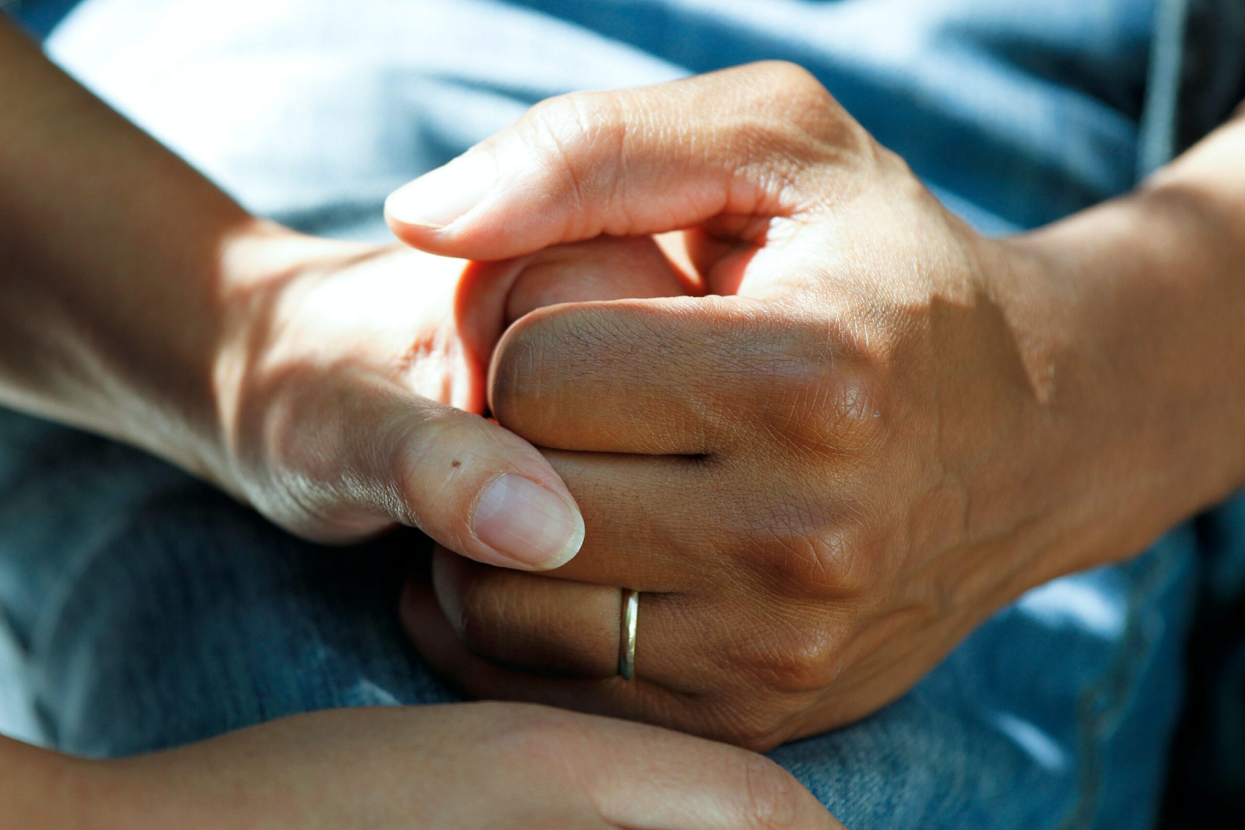 Thank You and No Thank You close up of two hands holding each other