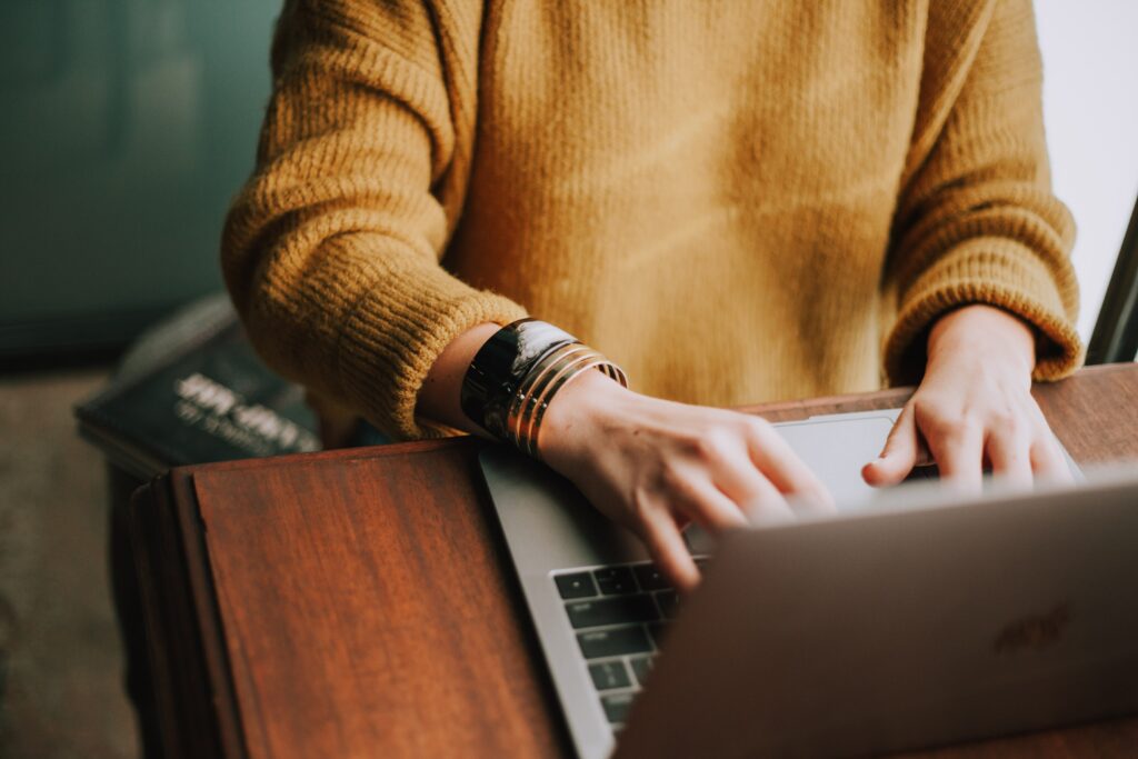 Learn About Your Four Bodies with Intro to You close up of a woman's hands on a laptop typing