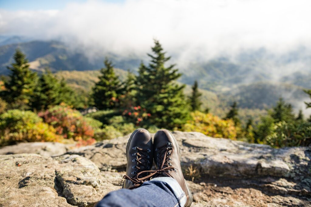 pair of brown boots overlooking a rocky edge in the mountains