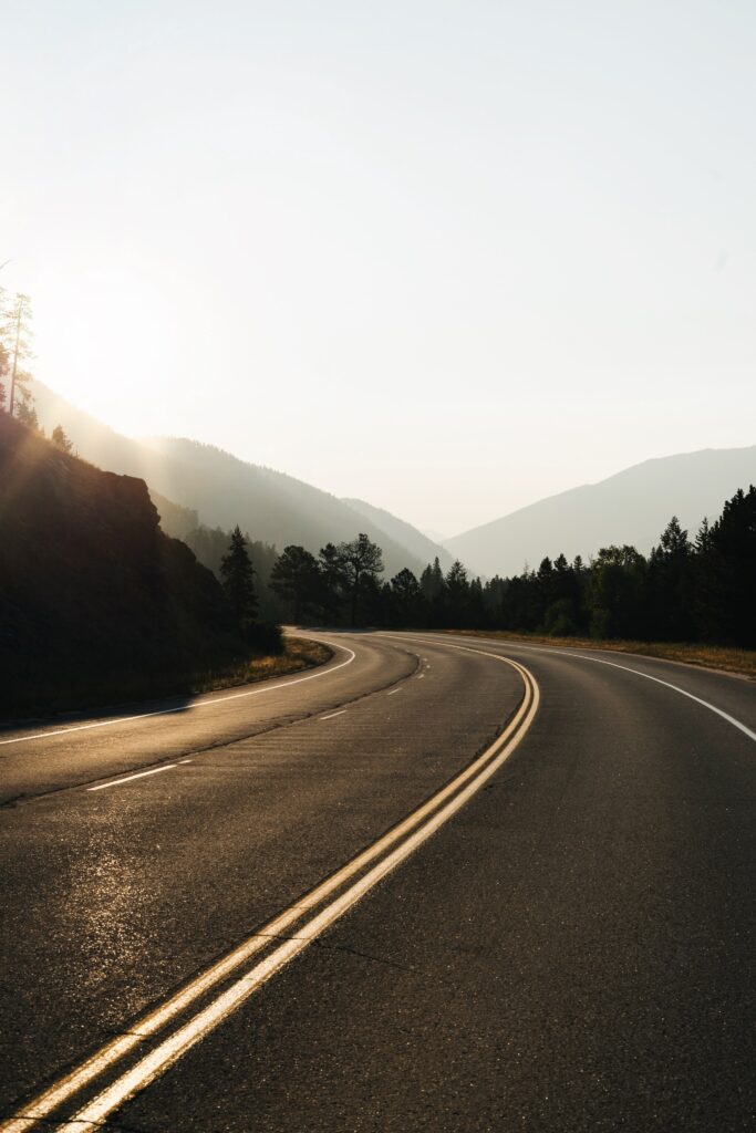 black asphalt road at sunset