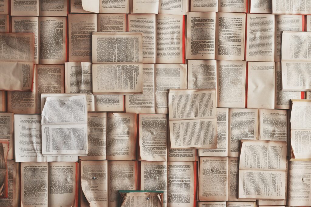 80: Tapping Into Logosynthesis® and the Power of Words with Dr. Laurie Weiss birds eye view of lots of books open to pages with words